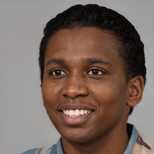Joyful black young-adult male with short  black hair and brown eyes