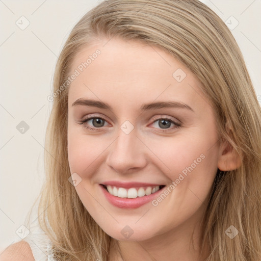 Joyful white young-adult female with long  brown hair and blue eyes