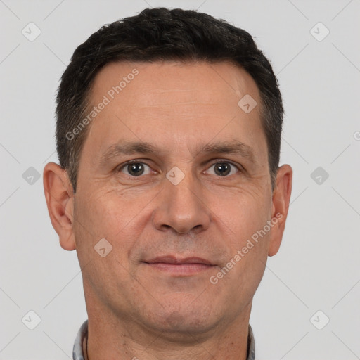 Joyful white adult male with short  brown hair and brown eyes