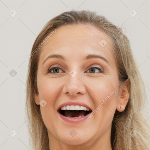 Joyful white young-adult female with long  brown hair and grey eyes