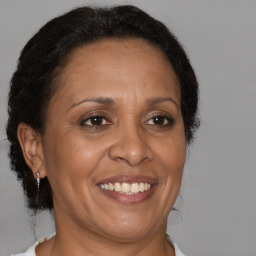 Joyful black adult female with medium  brown hair and brown eyes