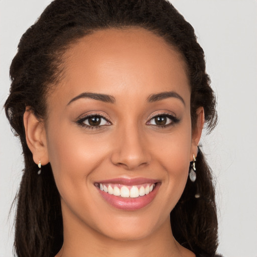 Joyful white young-adult female with long  brown hair and brown eyes