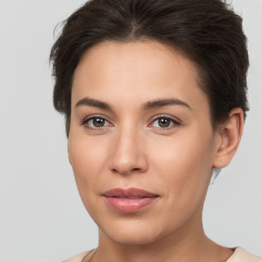 Joyful white young-adult female with short  brown hair and brown eyes