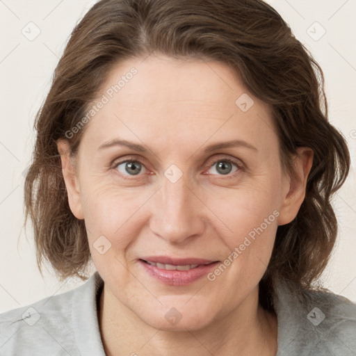 Joyful white adult female with medium  brown hair and grey eyes