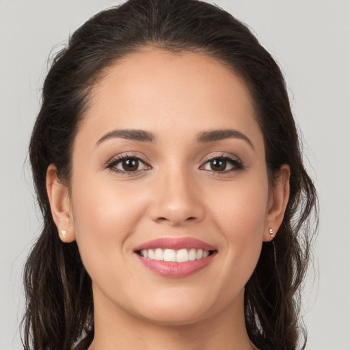 Joyful white young-adult female with long  brown hair and brown eyes