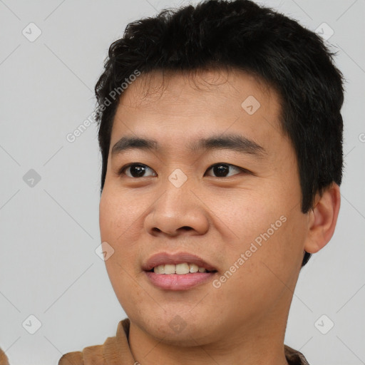 Joyful asian young-adult male with short  black hair and brown eyes