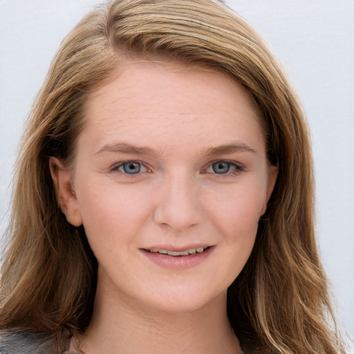 Joyful white young-adult female with long  brown hair and blue eyes