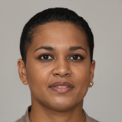 Joyful black young-adult female with short  brown hair and brown eyes