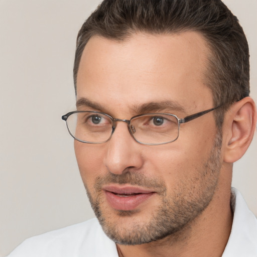 Joyful white adult male with short  brown hair and brown eyes