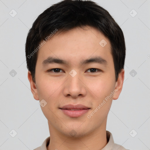 Joyful asian young-adult male with short  brown hair and brown eyes