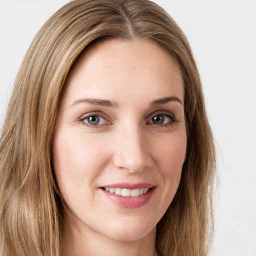 Joyful white young-adult female with long  brown hair and green eyes