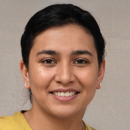 Joyful white young-adult female with short  brown hair and brown eyes