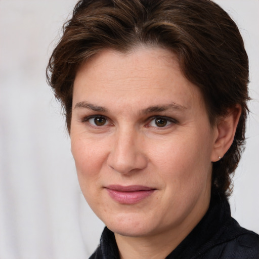 Joyful white adult female with medium  brown hair and brown eyes