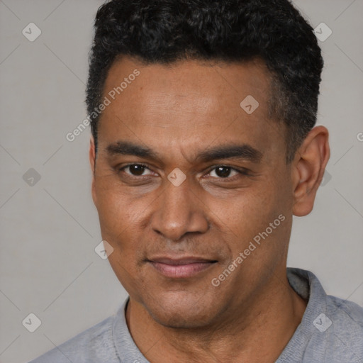 Joyful latino adult male with short  black hair and brown eyes