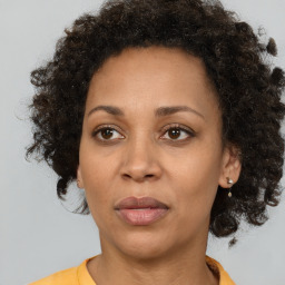 Joyful black adult female with short  brown hair and brown eyes