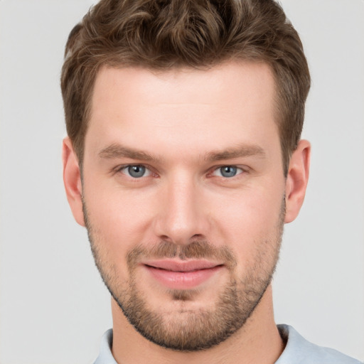 Joyful white young-adult male with short  brown hair and grey eyes