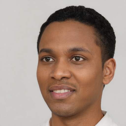 Joyful black young-adult male with short  black hair and brown eyes