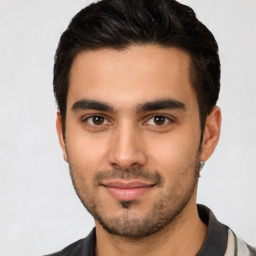 Joyful latino young-adult male with short  brown hair and brown eyes