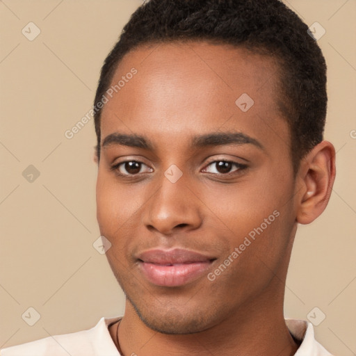 Joyful black young-adult male with short  brown hair and brown eyes