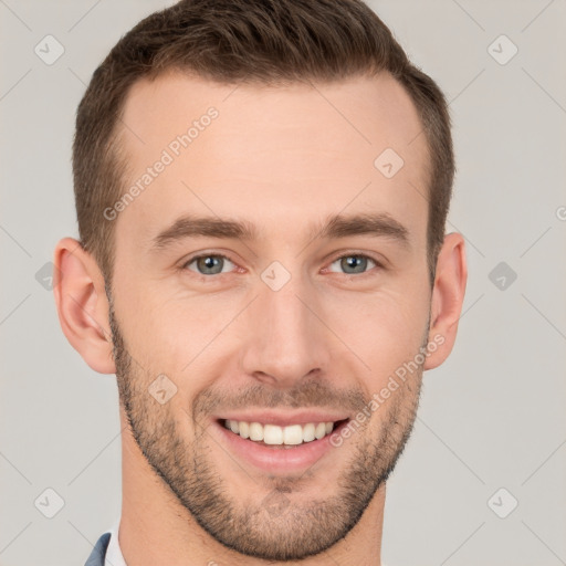 Joyful white young-adult male with short  brown hair and grey eyes