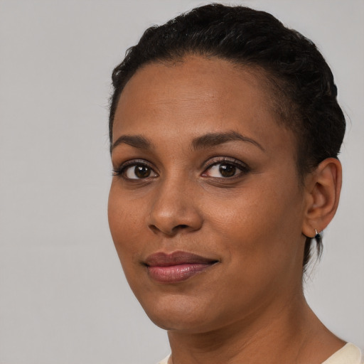 Joyful latino young-adult female with short  black hair and brown eyes