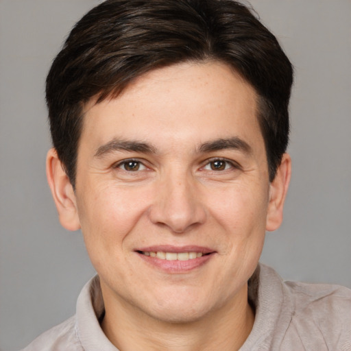 Joyful white adult male with short  brown hair and brown eyes