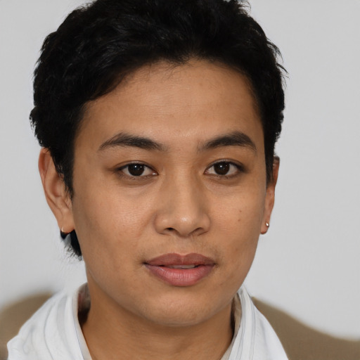 Joyful latino young-adult female with short  black hair and brown eyes