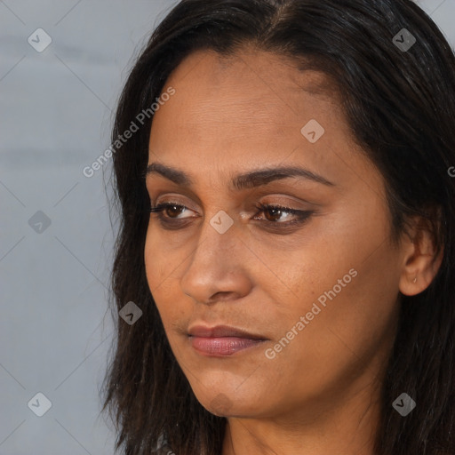 Joyful black adult female with long  brown hair and brown eyes