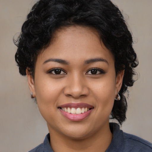 Joyful latino young-adult female with short  brown hair and brown eyes