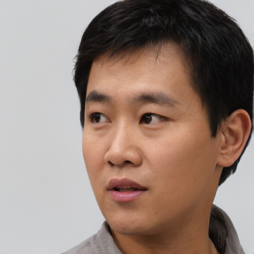 Neutral asian young-adult male with short  black hair and brown eyes