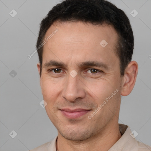 Joyful white adult male with short  brown hair and brown eyes