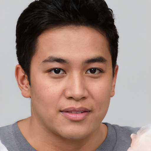 Joyful asian young-adult male with short  brown hair and brown eyes