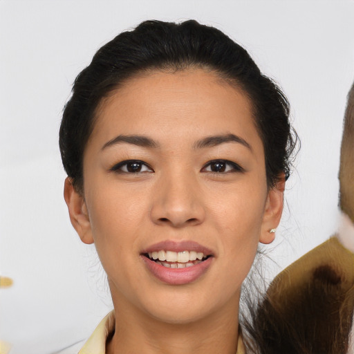 Joyful asian young-adult female with medium  black hair and brown eyes
