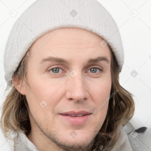 Joyful white young-adult male with medium  brown hair and grey eyes