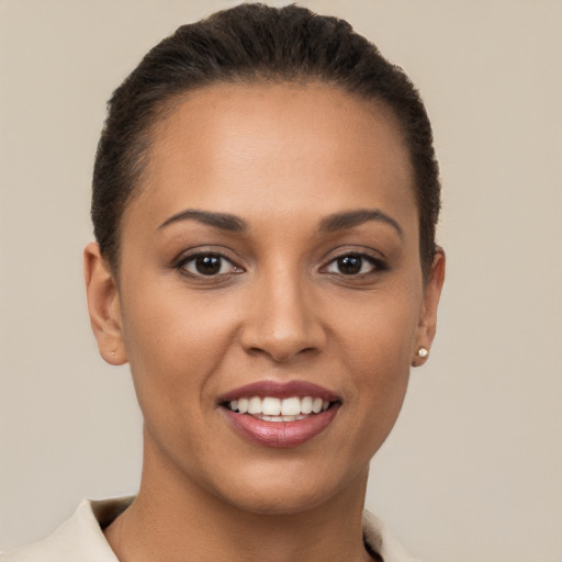 Joyful latino young-adult female with short  brown hair and brown eyes