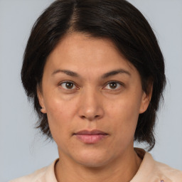 Joyful white adult female with medium  brown hair and brown eyes