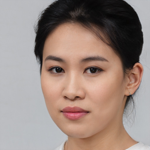Joyful asian young-adult female with medium  brown hair and brown eyes