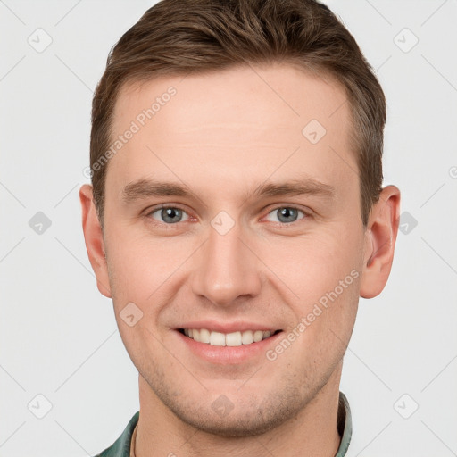 Joyful white young-adult male with short  brown hair and grey eyes