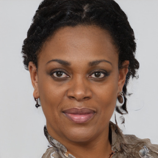 Joyful black adult female with short  brown hair and brown eyes