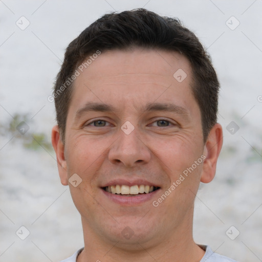 Joyful white adult male with short  brown hair and brown eyes