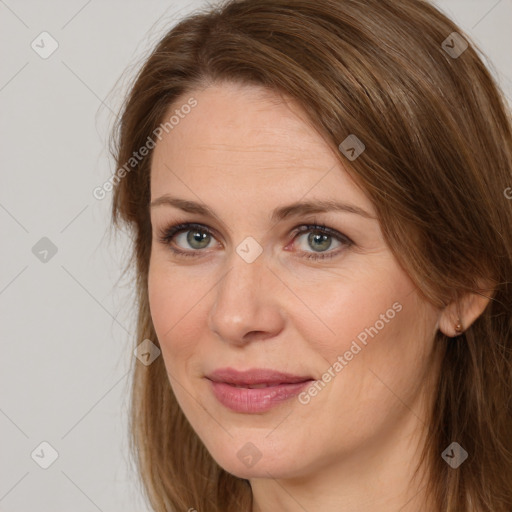 Joyful white adult female with long  brown hair and brown eyes