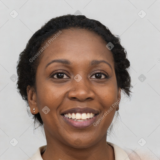 Joyful black young-adult female with long  brown hair and brown eyes