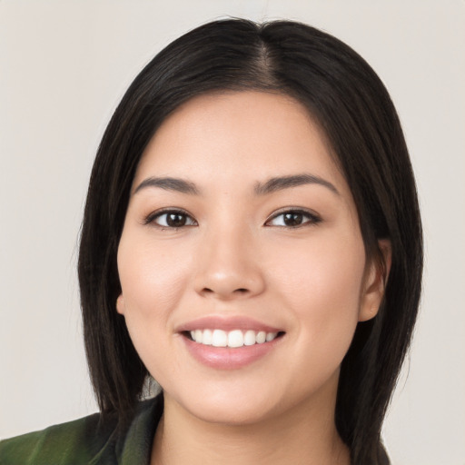 Joyful white young-adult female with medium  black hair and brown eyes