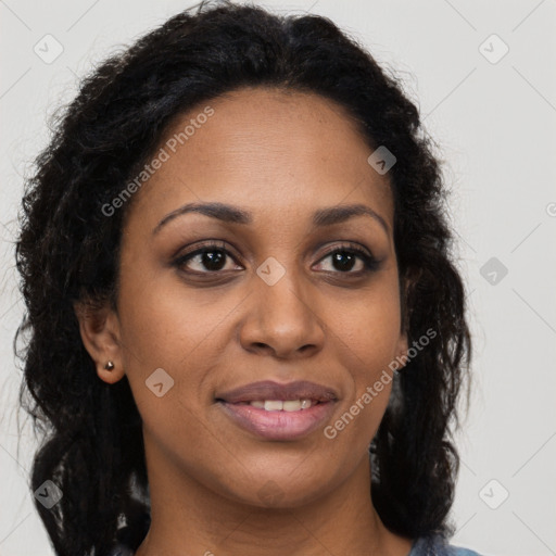 Joyful black young-adult female with long  brown hair and brown eyes