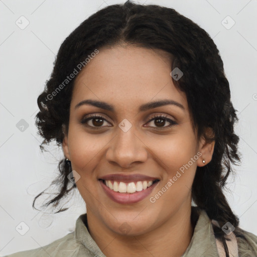 Joyful black young-adult female with long  brown hair and brown eyes