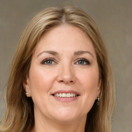 Joyful white adult female with long  brown hair and green eyes