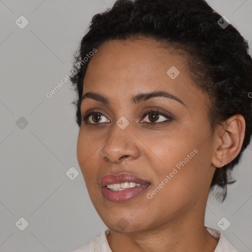 Joyful black young-adult female with short  black hair and brown eyes