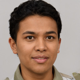 Joyful latino young-adult male with short  brown hair and brown eyes