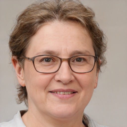 Joyful white middle-aged female with short  brown hair and blue eyes