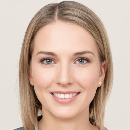 Joyful white young-adult female with long  brown hair and grey eyes